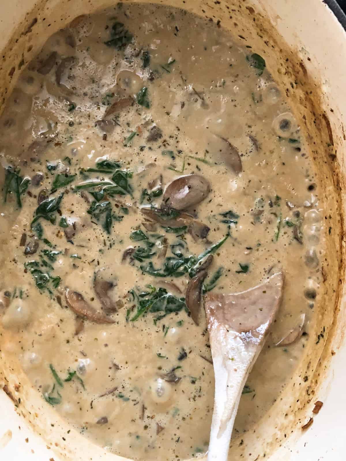 Creamy vegan mushroom sauce in a Dutch oven.