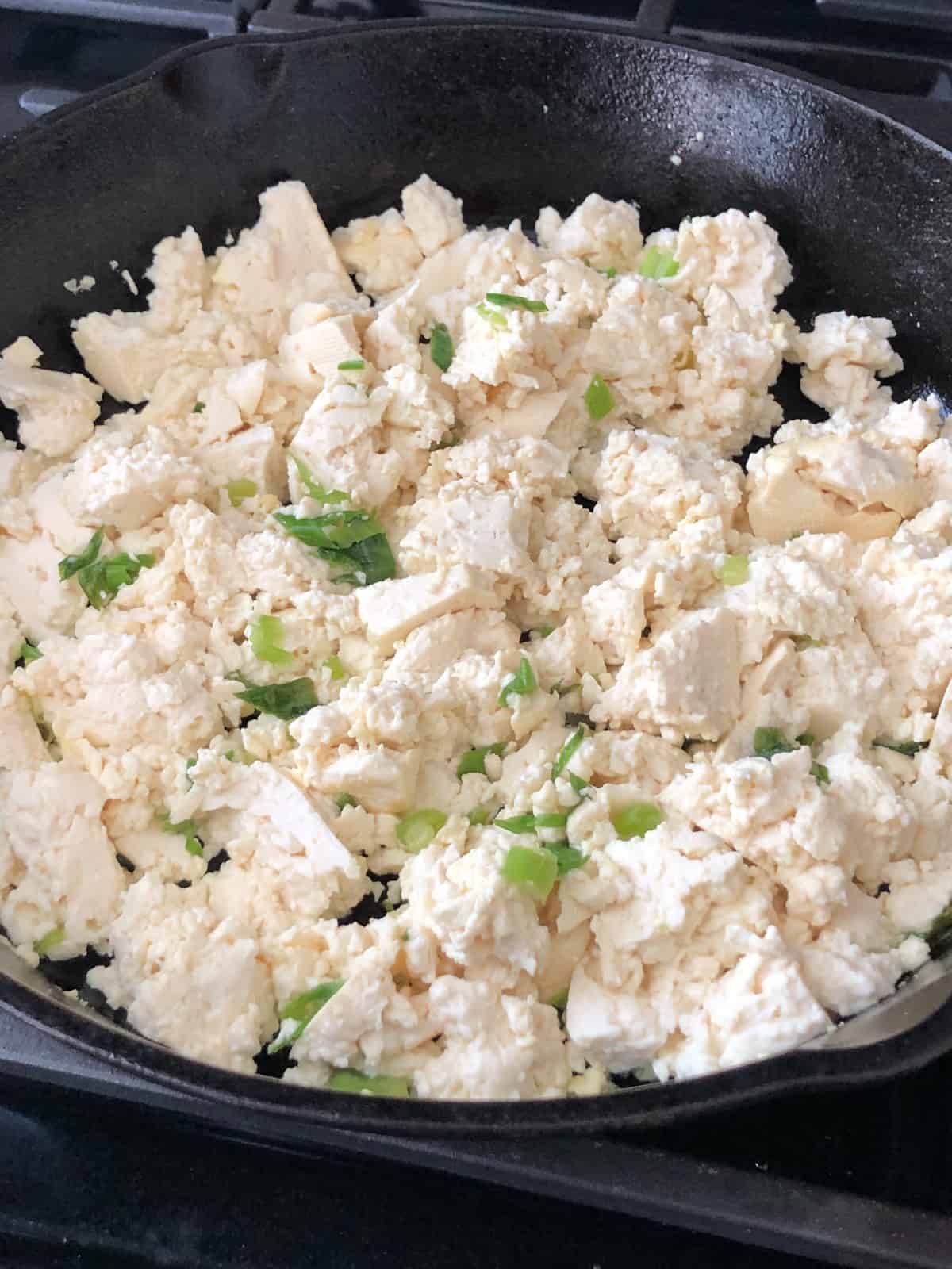 Fluffy vegan scrambled tofu eggs in a skillet.
