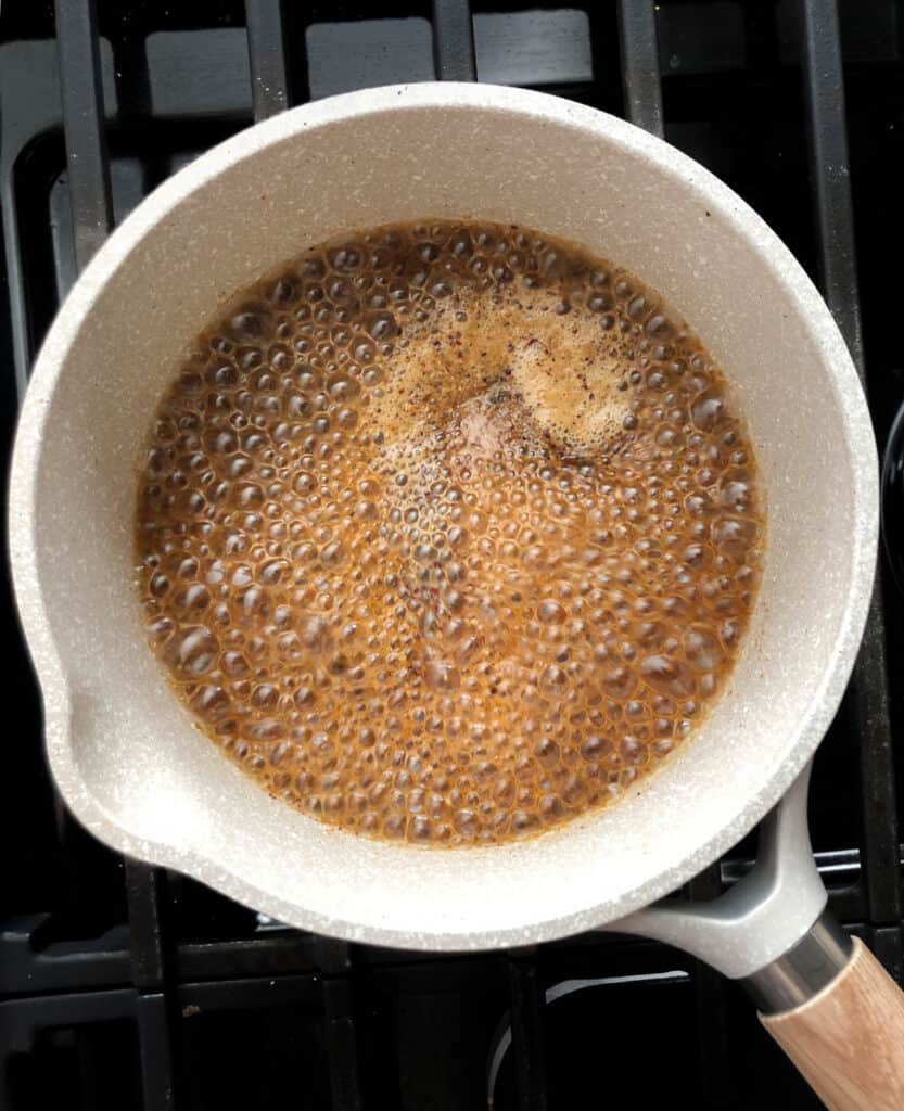 Worcester sauce boiling in a saucepan on the stove.