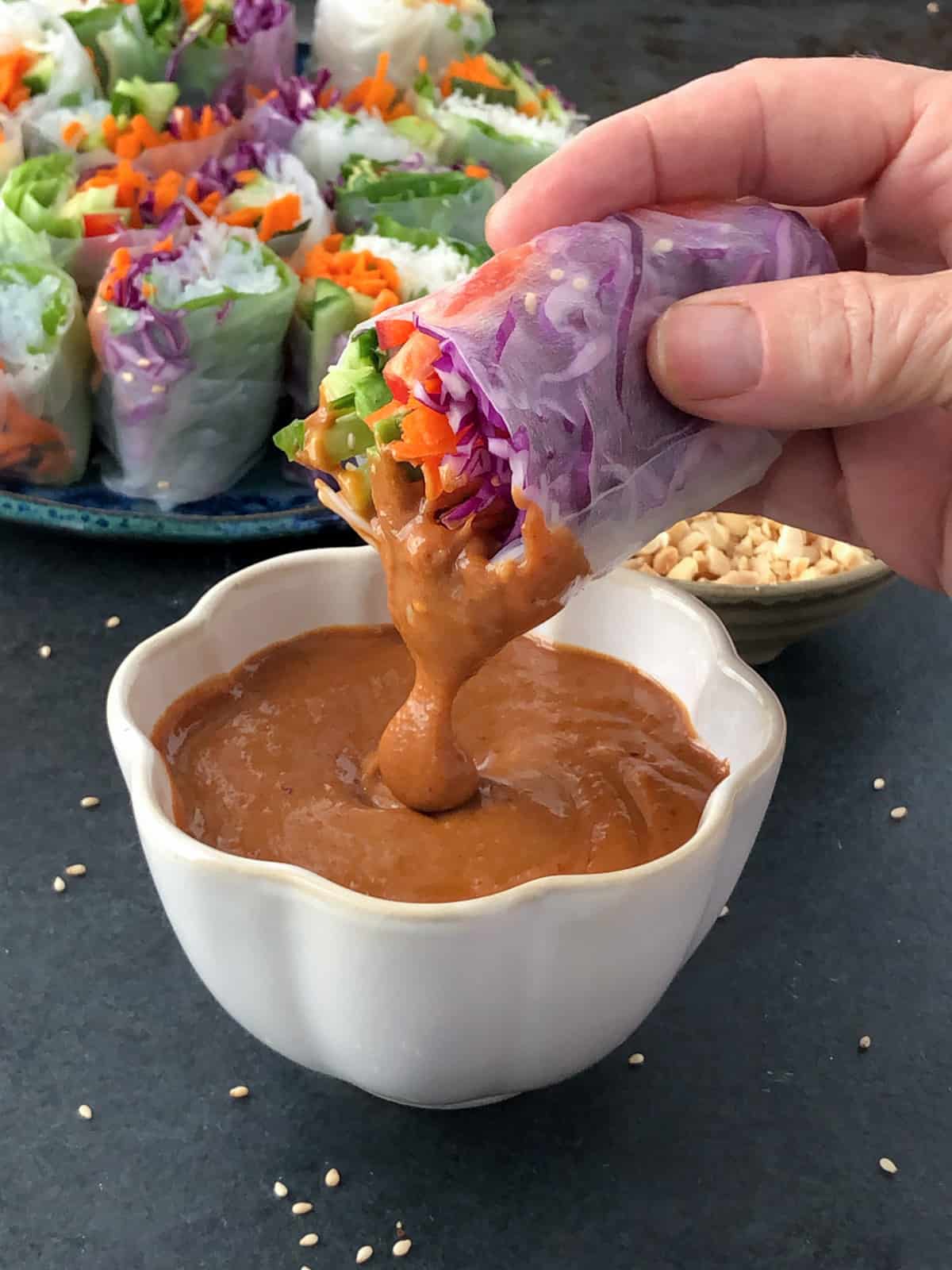 Vegetarian salad rolls dipped in spicy peanut dipping sauce.