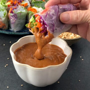 Vietnamese spring roll dipped in peanut sauce.