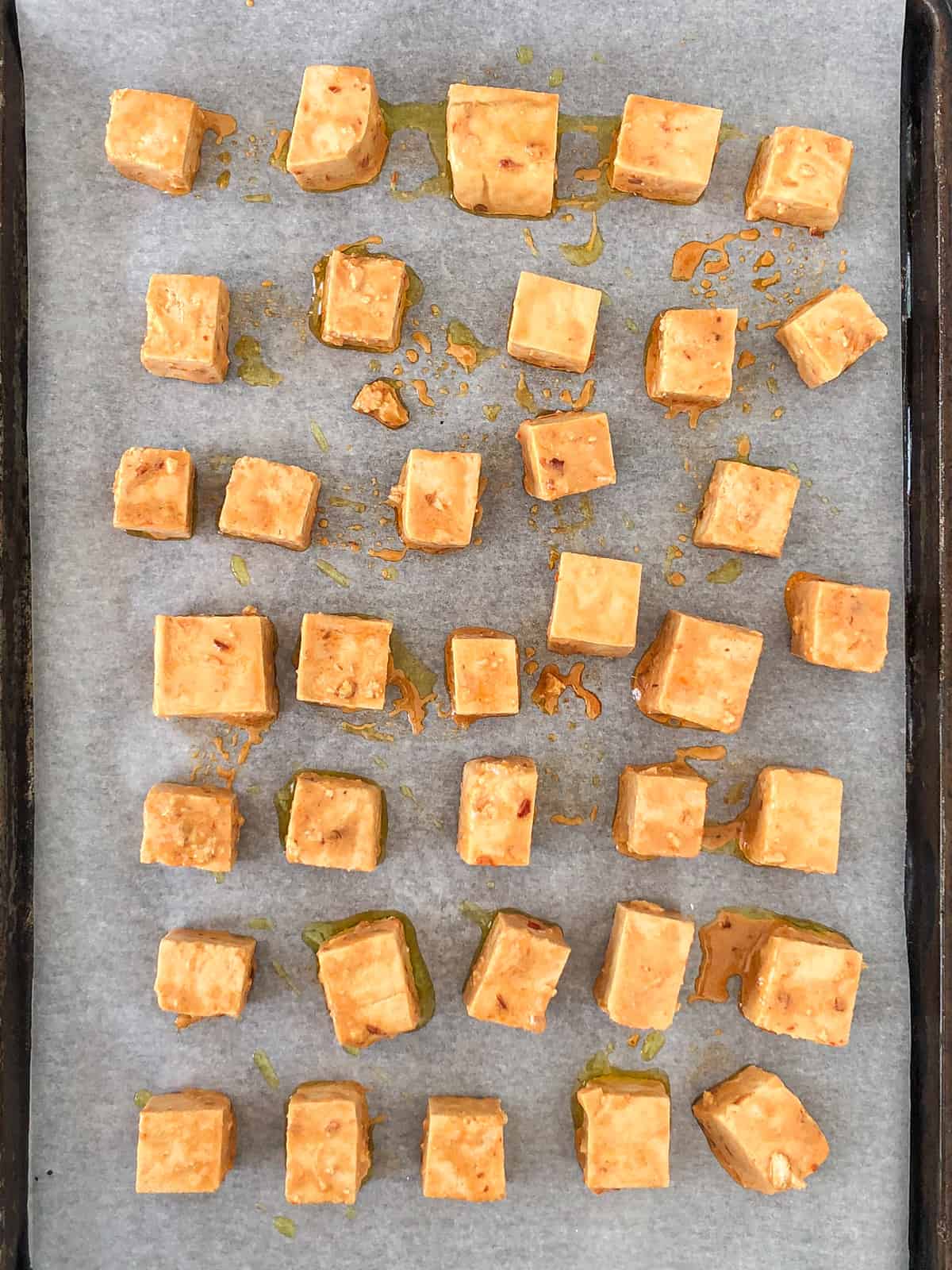 Tofu cubes before and after being baked.