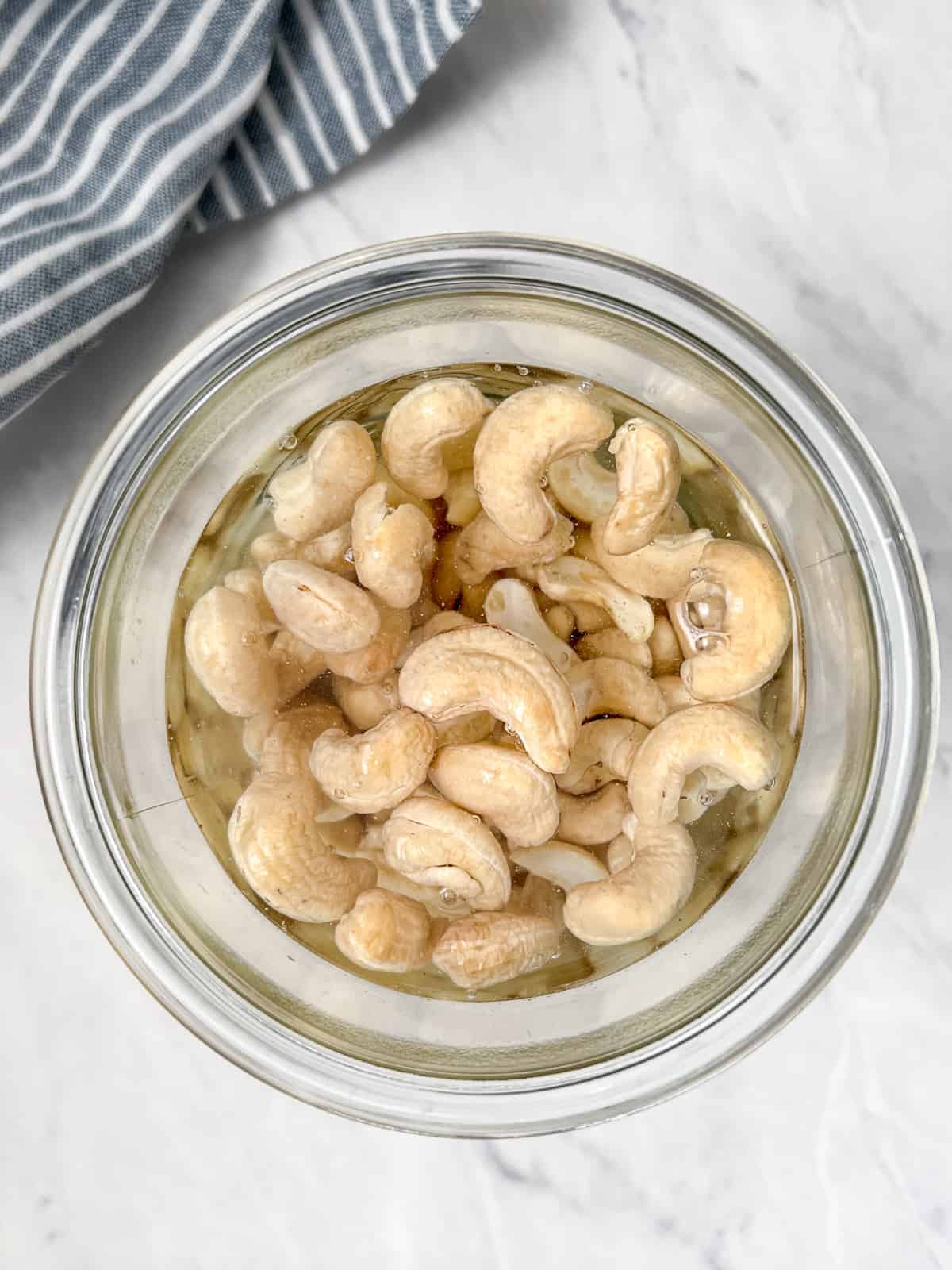 Cashews soaking in a jar of water.