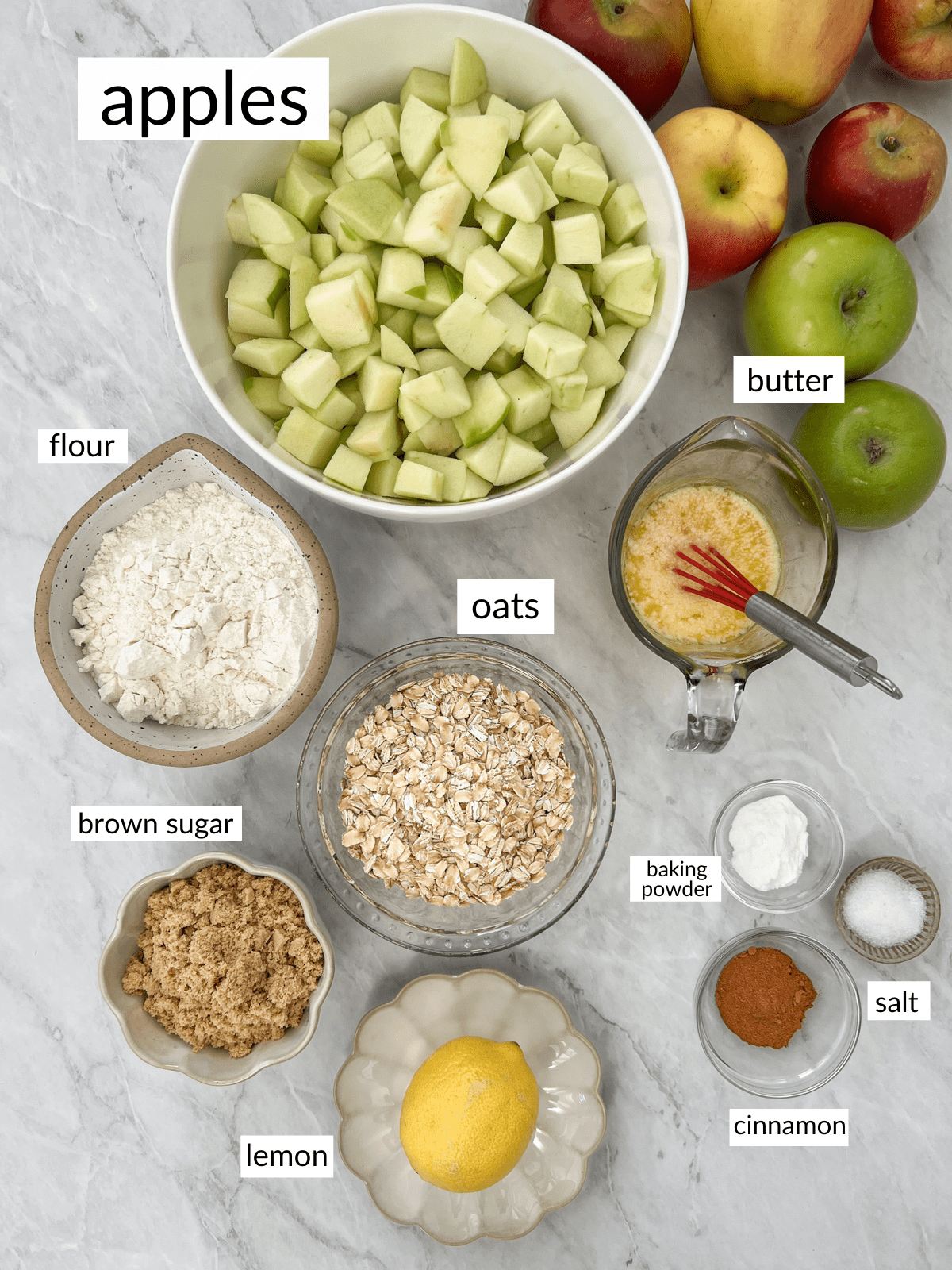 Ingredients in small bowls for apple crisp.