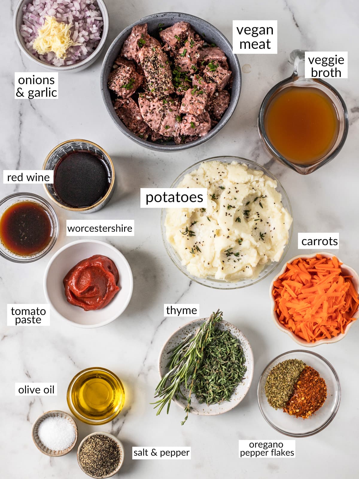 Ingredients for shepherds pie in individual dishes on a marble counter.