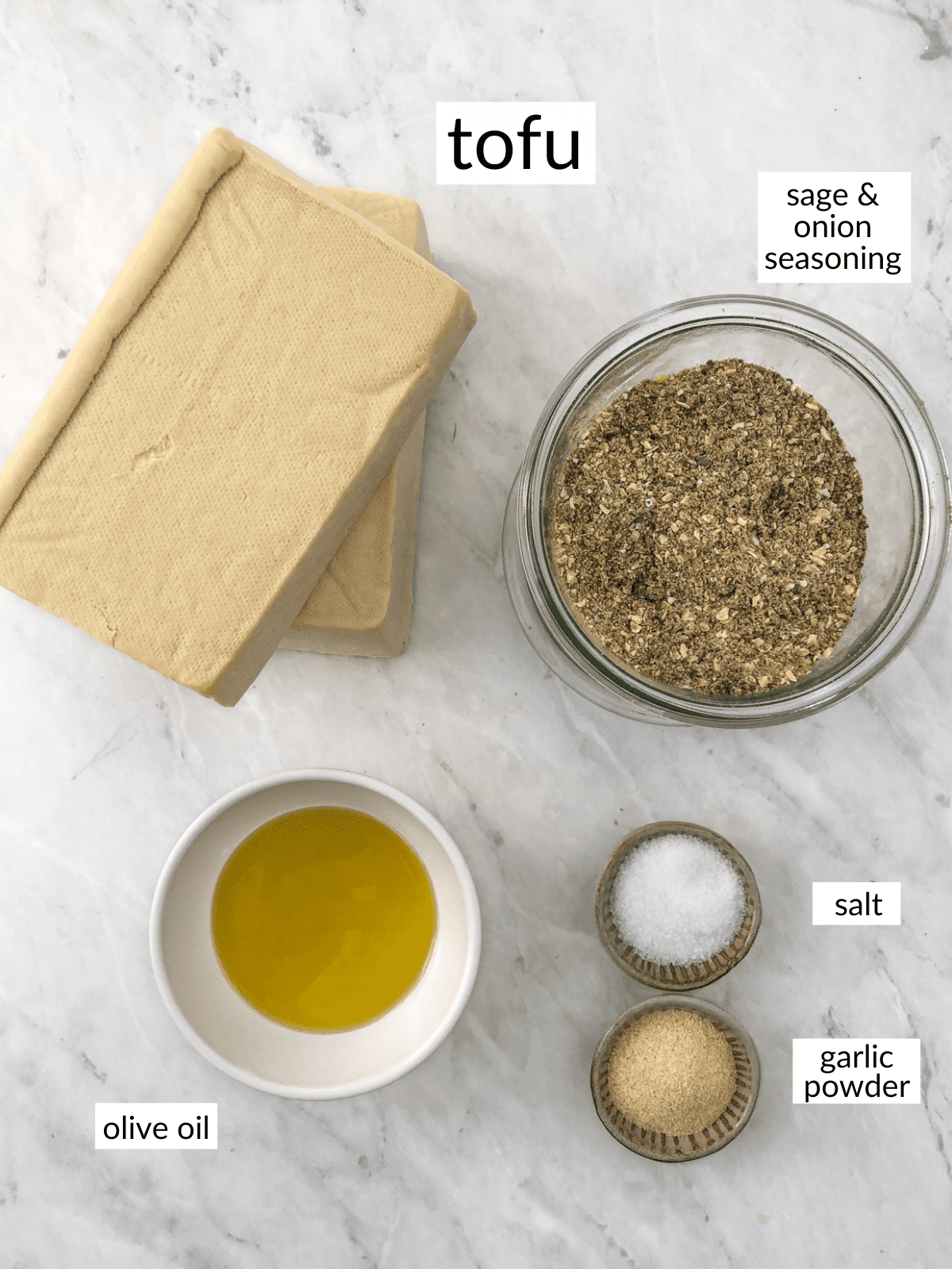 Tofu, turkey seasoning, oil and pots of salt and garlic powder.
