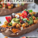 Stuffed baked sweet potatoes topped with tomatoes, avocado and black beans.