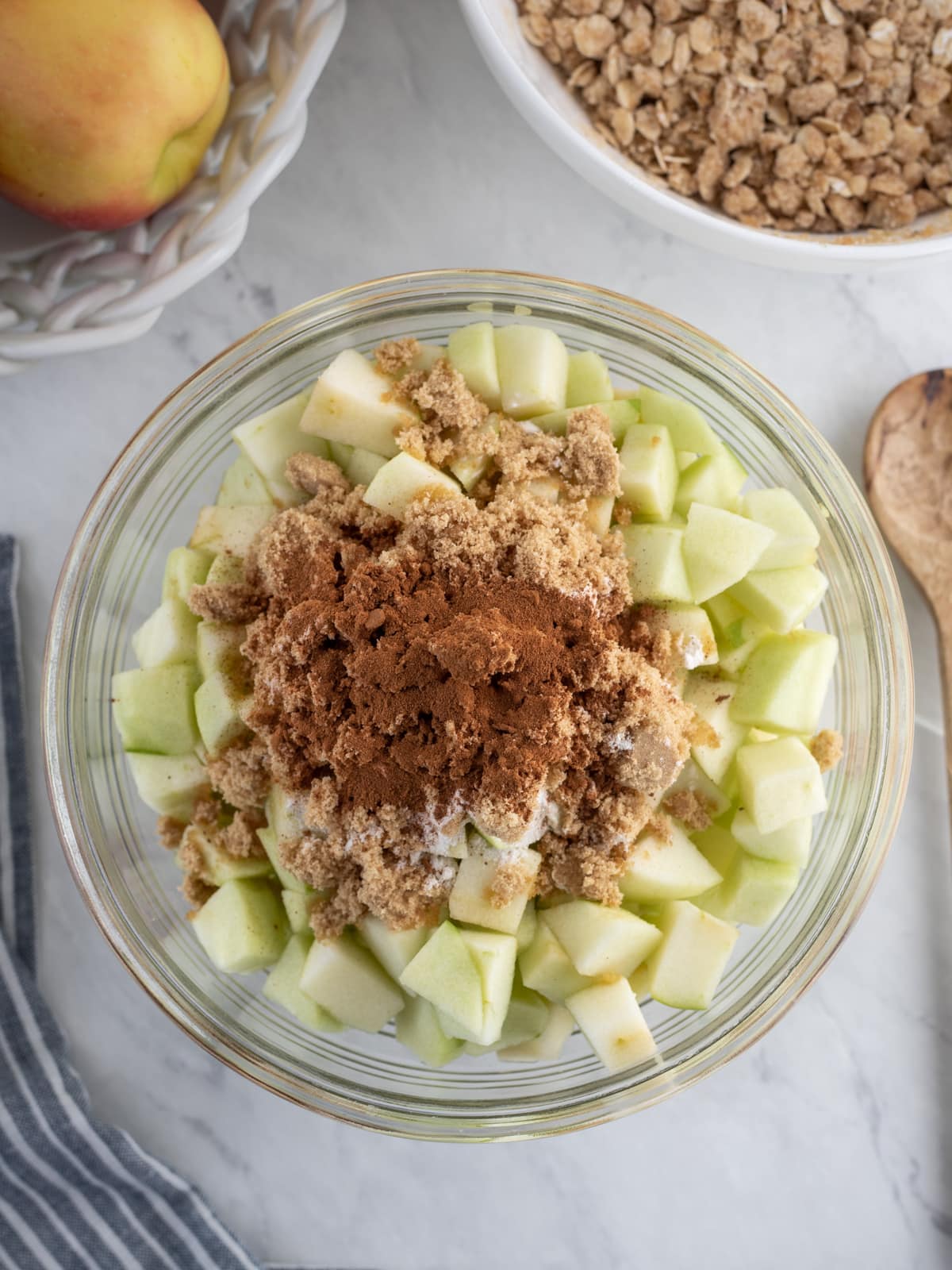 Bowlful of diced granny smith apples with cinnamon spice on top.