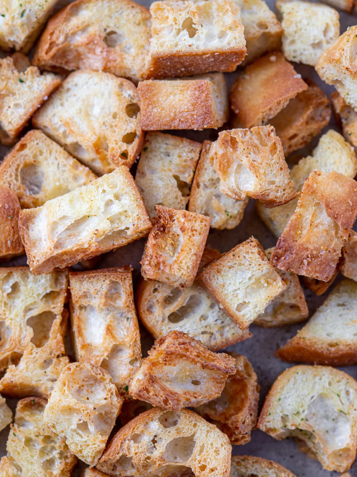 Close up of freshly baked croutons on a baking sheet.