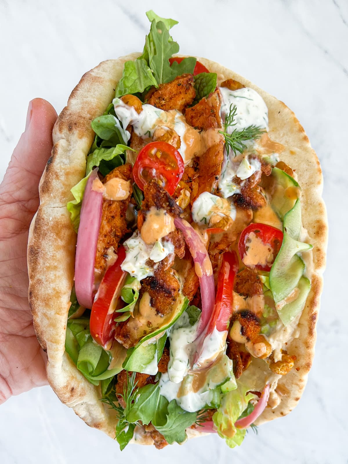 Large vegan shawarma being held in one hand.