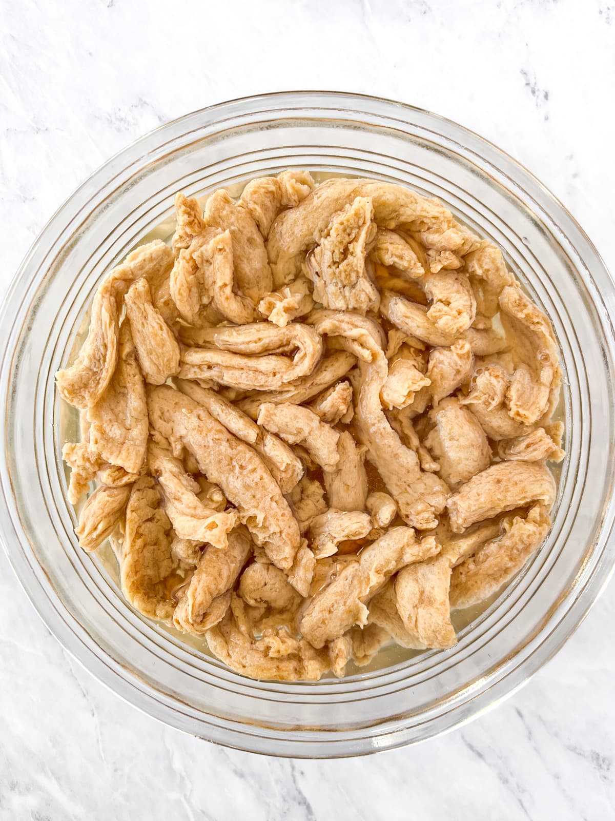 Soy curls in a bowl of water.