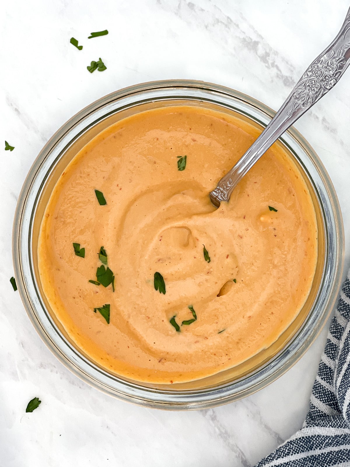 Bowl of chipotle cashew sauce with serving spoon.