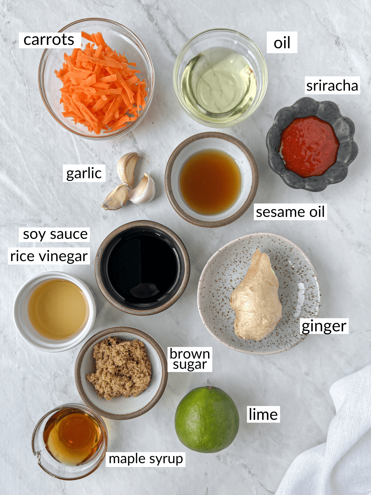 Small bowls filled with ingredients to make a dairy-free Asian slaw dressing.