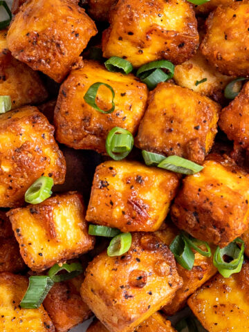 Crispy air fried tofu covered with sliced green onions.