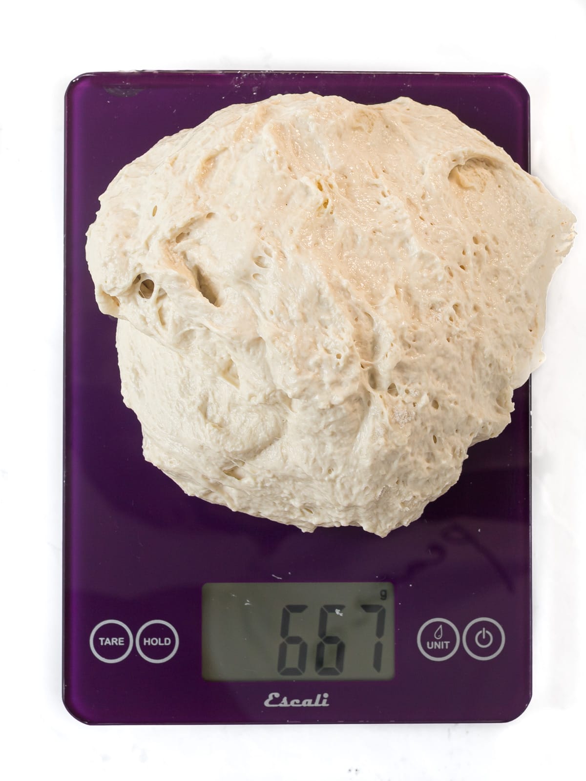 Large piece of dough on kitchen scale.