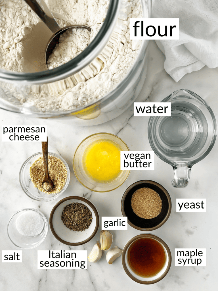 Ingredients to make homemade breadsticks in jars on a counter.