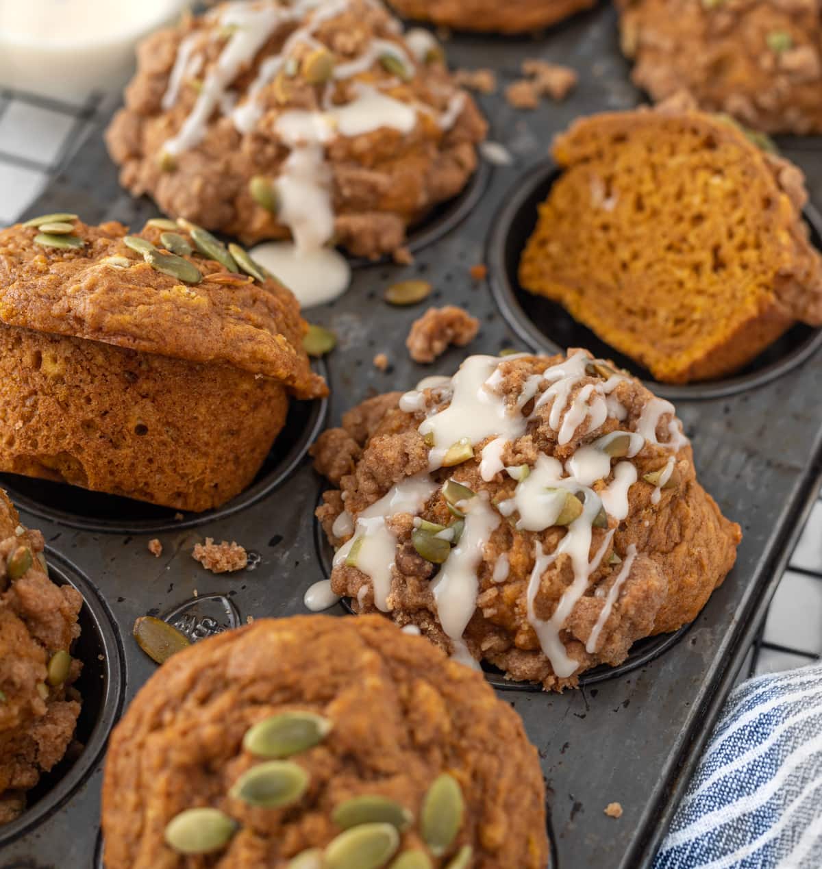 Pan of pumpkin muffins with frosting drizzling 