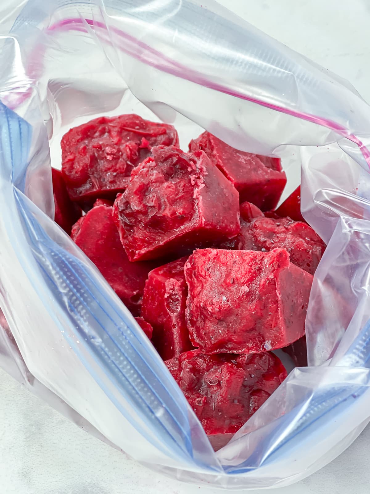 Cranberry sauce ice cubes in a freezer bag.
