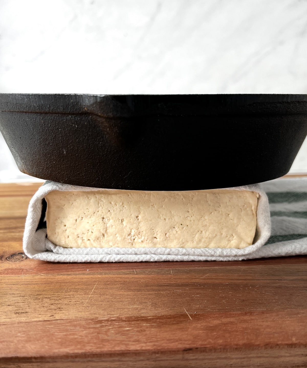 Cast iron pan on a block of tofu to press out water.