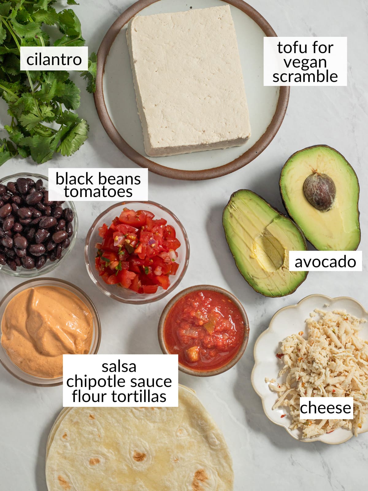 Plant based breakfast burrito ingredients in individual dishes.