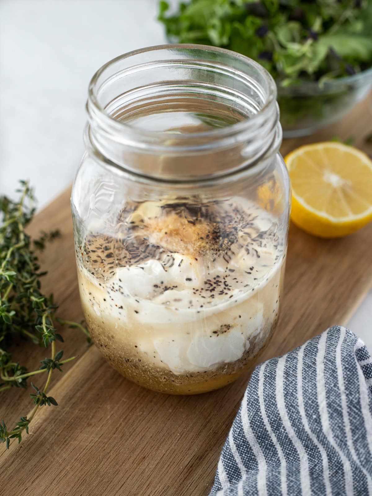 Ingredients for creamy white balsamic vinaigrette in a jar ready to shake.