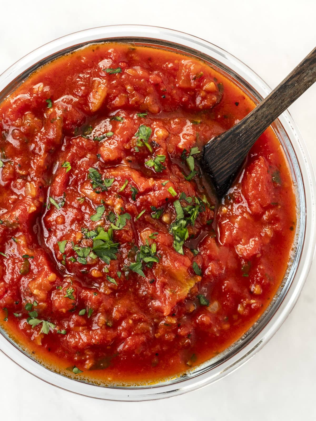 Top down view of homemade marinara sauce in a jar.