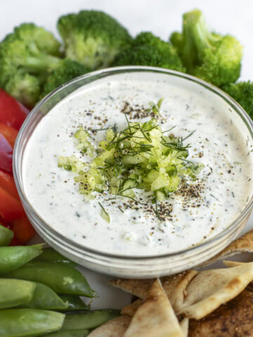 Bowlful of tzatziki sauce on a veggie platter.